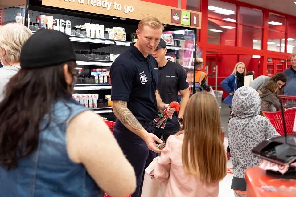 A firefighter shopping with a child.