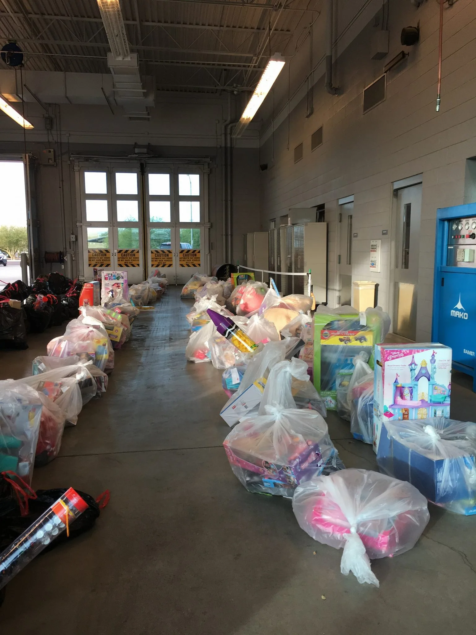 Donated toys sorted in a fire station bay.
