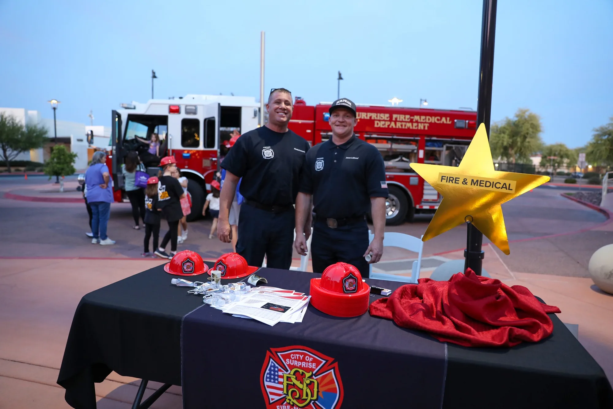 Firefighters at a community outreach table.